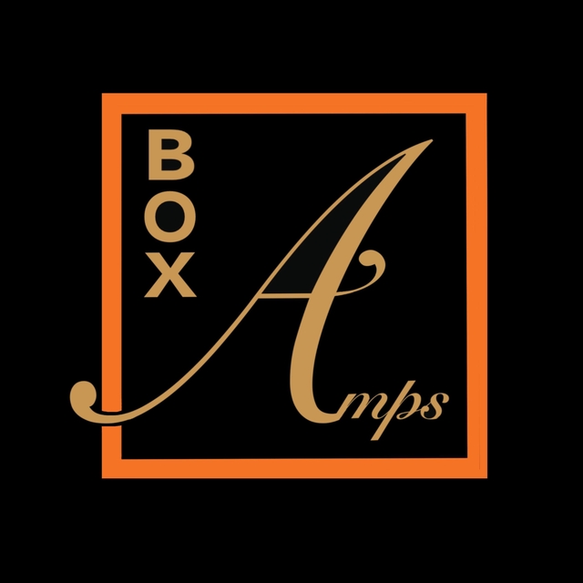 The BoxAmps logo. Black square with a thin orange outline. The word BOX is written in capitals and is displayed on the top left of the square, written vertically. Amps is written horizontally with a cursive font and takes up the rest of the interior of the square. The A of amps is much bigger than the other letters and is partially outside the orange border of the logo. BoxAmps are portable guitar practice amps and speakers for music playback