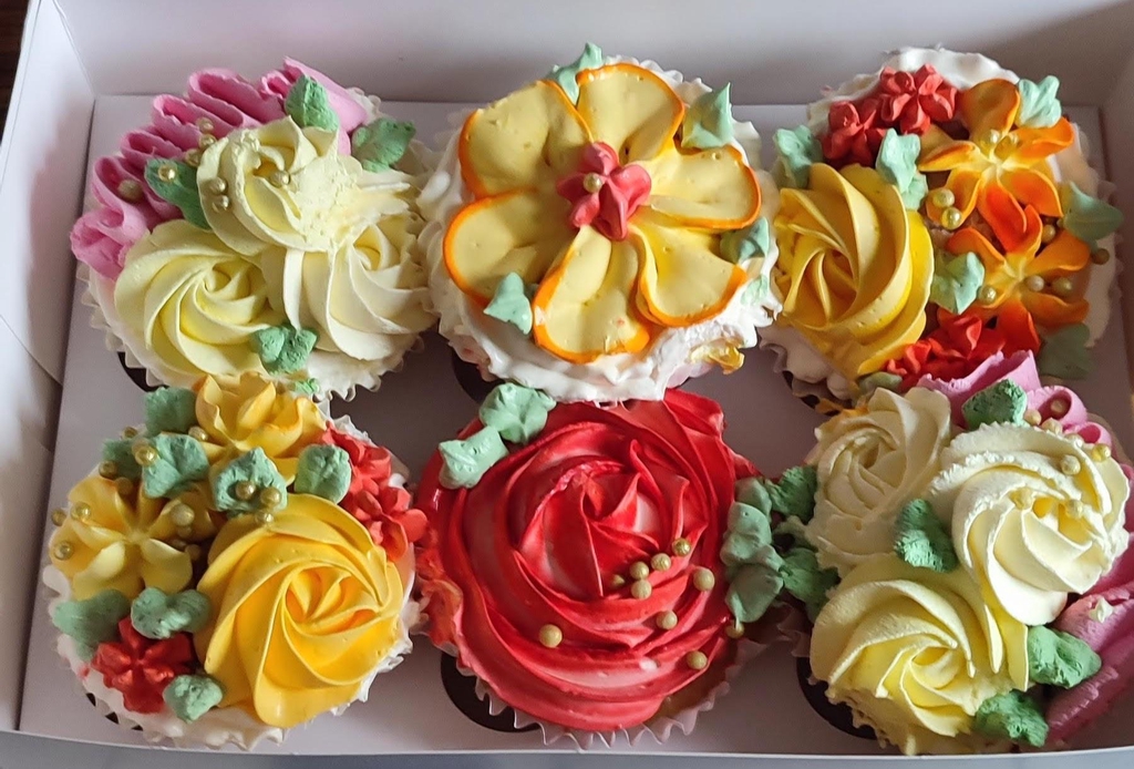 Beautiful colourful creamy cupcakes.