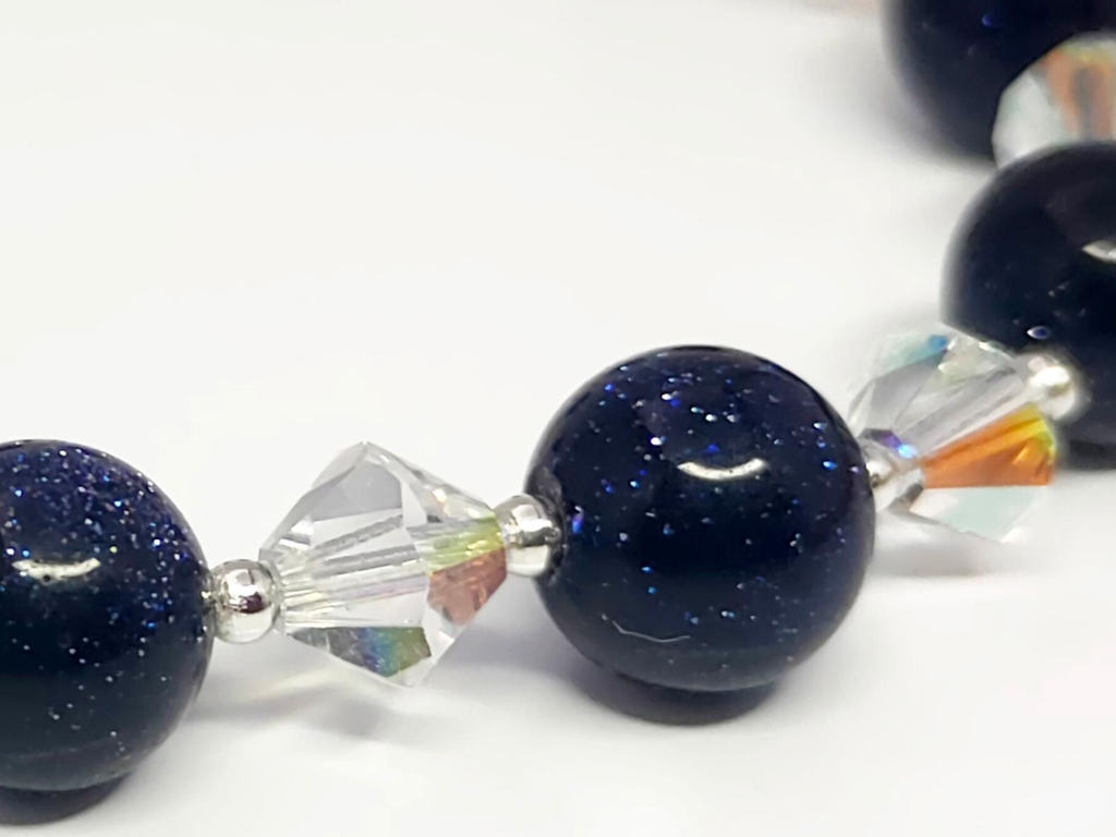 Sparkling blue beads and crystal bicones intersected by tiny sterling silver beads.