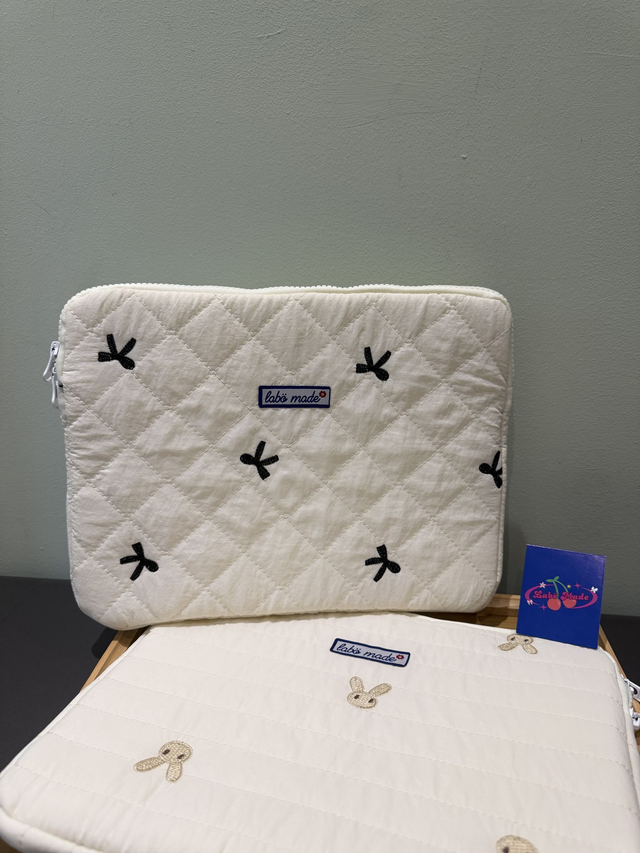 Quilted laptop sleeve with floral or pastel design, padded for protection and stylish enough for school or work.