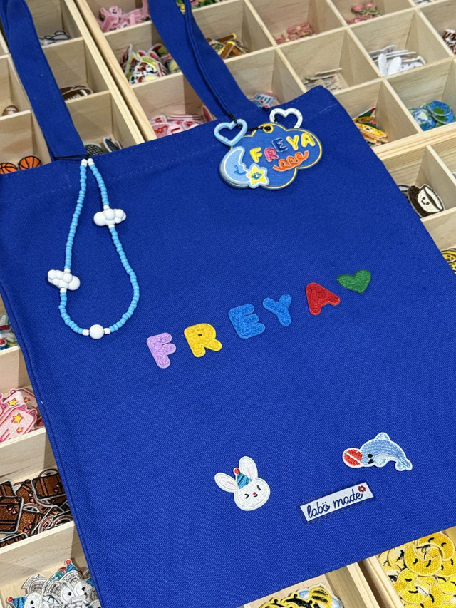 Cotton canvas tote bag with minimalist or hand-drawn design, reusable and eco-friendly.