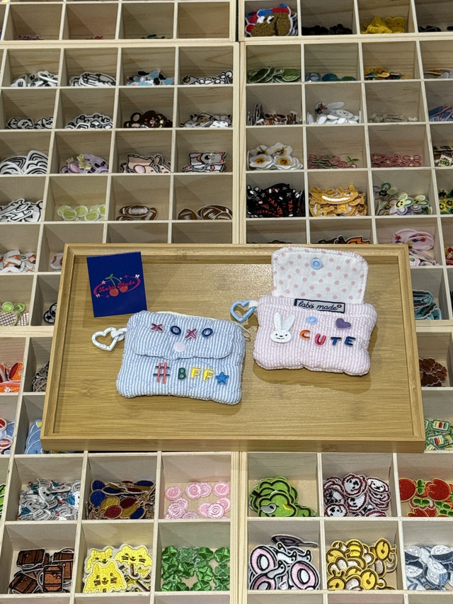 Colourful zip-up coin pouch made from durable cotton, perfect for cash, cards, or hair ties.