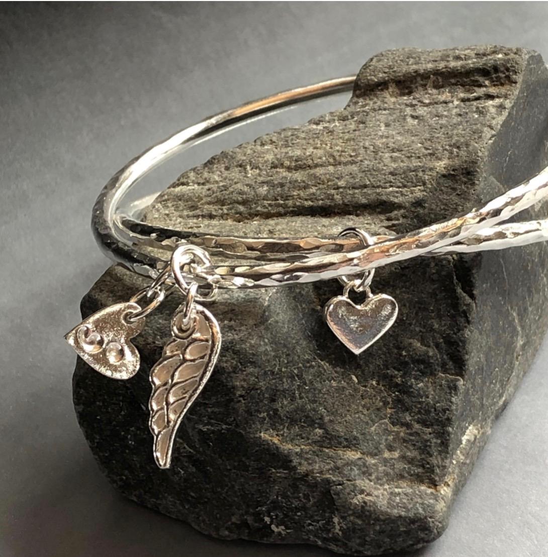 Handmade sterling silver and sea glass charms by Silverre inspired by coastal textures and natural forms.
