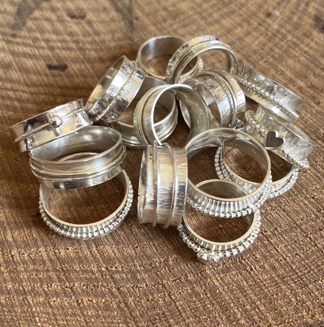 Handmade sterling silver rings by Silverre including spinning rings and fingerprint jewellery.