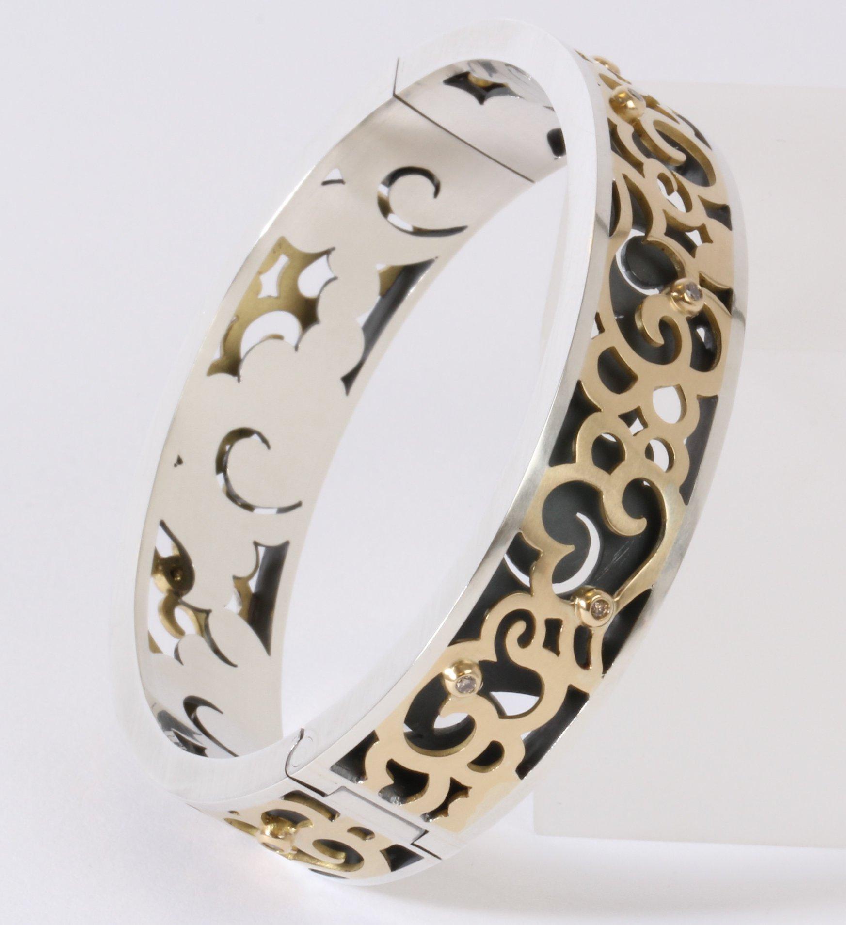 Award winning design, Kumo bangle: handmade hinged bangle with box catch. Made from sterling silver, 18 carat yellow gold, and upcycled champagne diamonds.