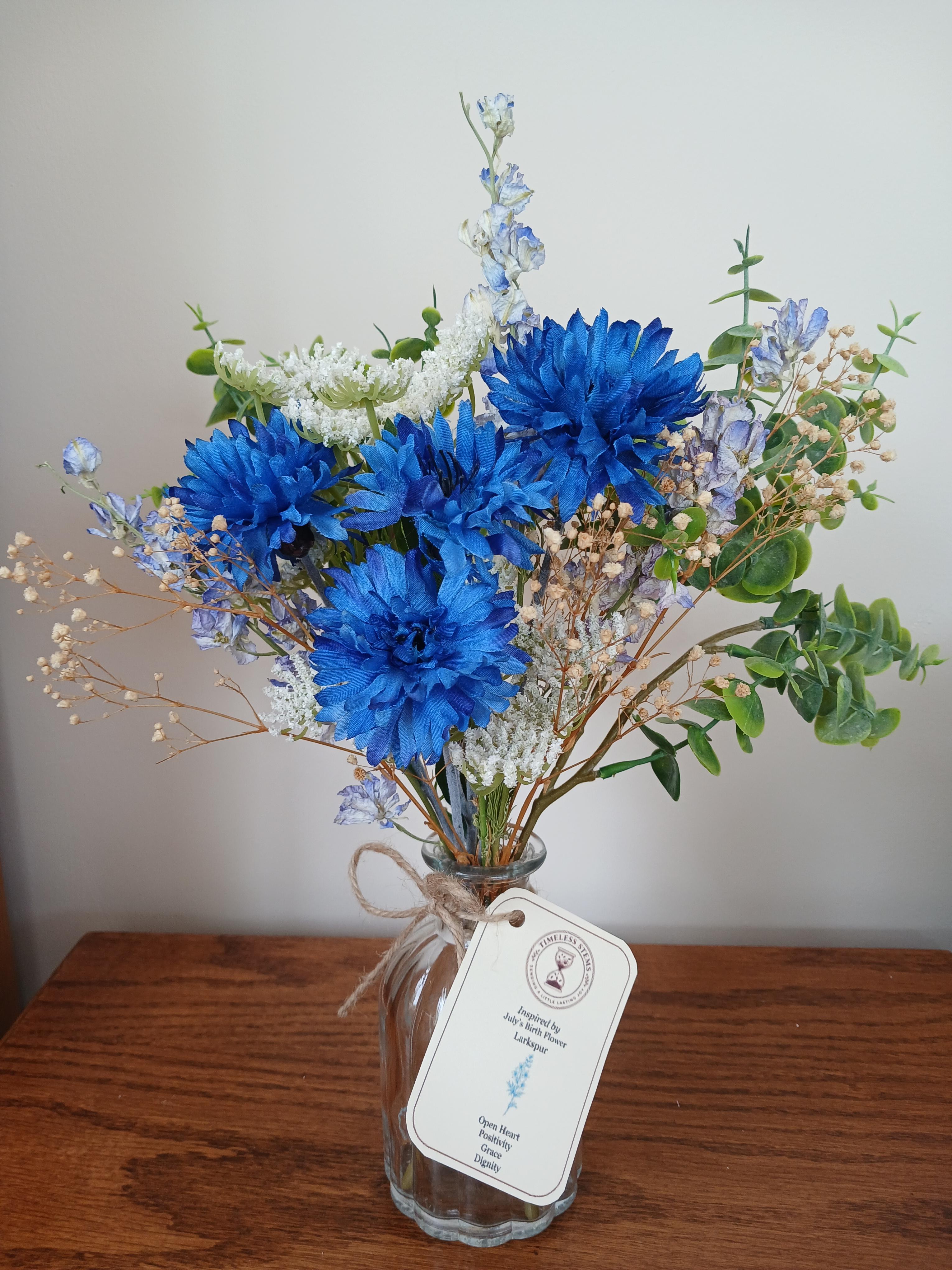 July
July birth flower posy inspired by larkspur, handcrafted with dried delphiniums and artificial cornflowers. A bright, uplifting gift.