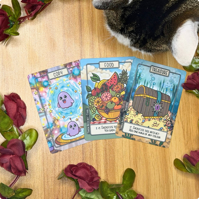 A spread of 3 hand-illustrated TCG tokens, perfect for EDH and Commander formats: Copy, Food and Treasure. The art style is cute and whimsical with black line art and incredible detail.