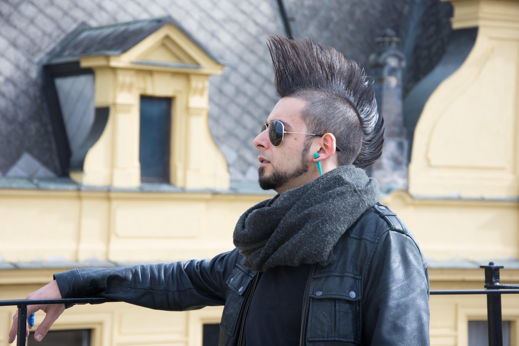 Ryan looking off into the distance with some beautiful rooftop scenery behind him