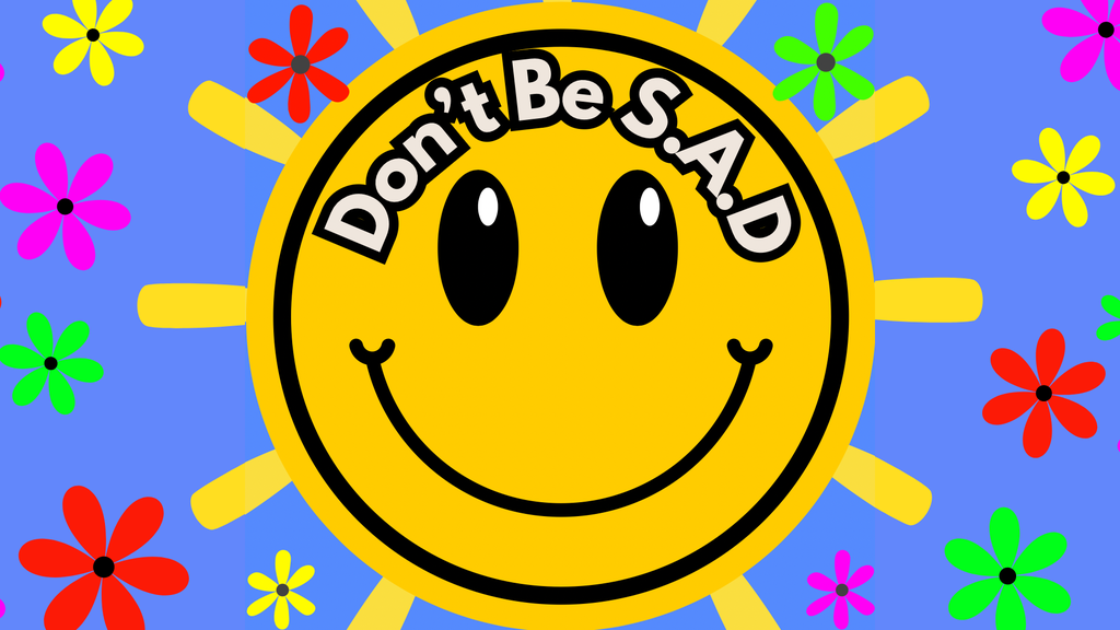 Don’t Be S.A.D’s logo is a smiling sun with flowers around the outside 

The background is sky blue and the smiley sun has the ‘Don’t Be S.A.D’ text written in a comical font