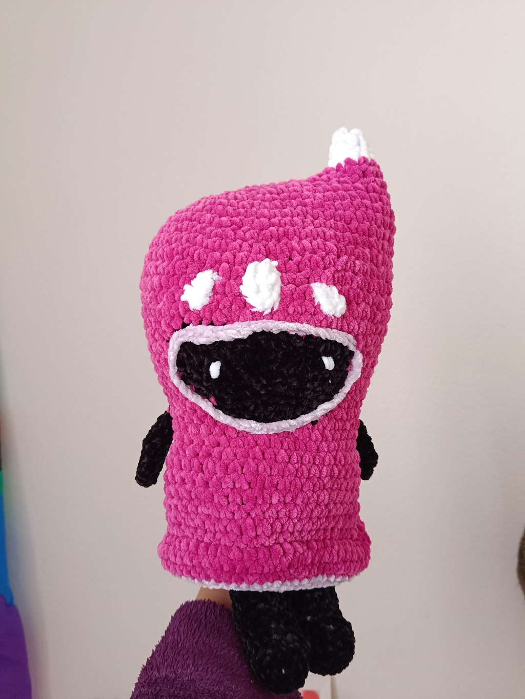 Un petit scout rose du jeu The Last Campfire en crochet