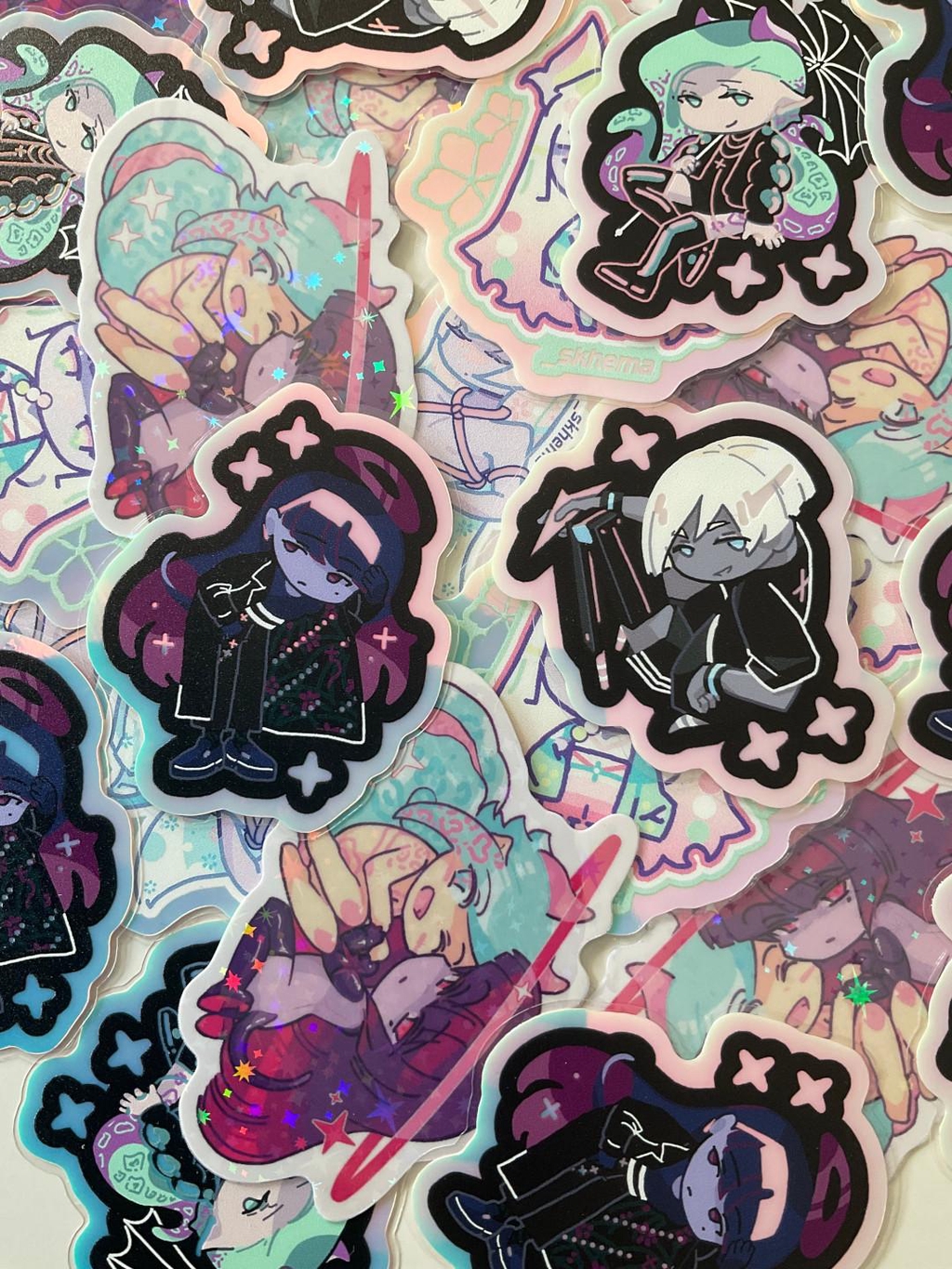 Stickers, many with strong glow-in-the-dark effect but also holographic at light. The characters are my OCs from my self-published BL / yaoi manga comic.