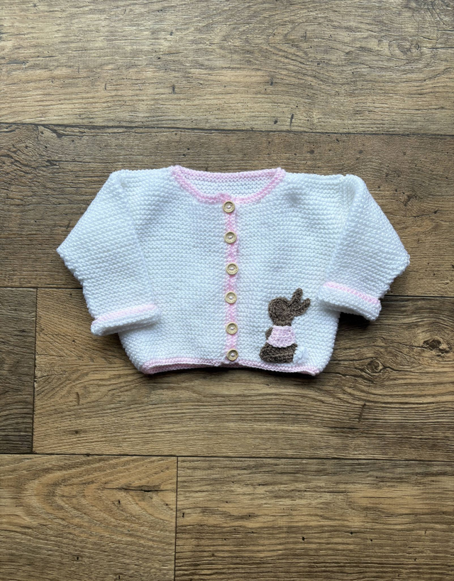 Handmade knitted baby knitwear including cardigans, jumpers, and cosy baby clothes