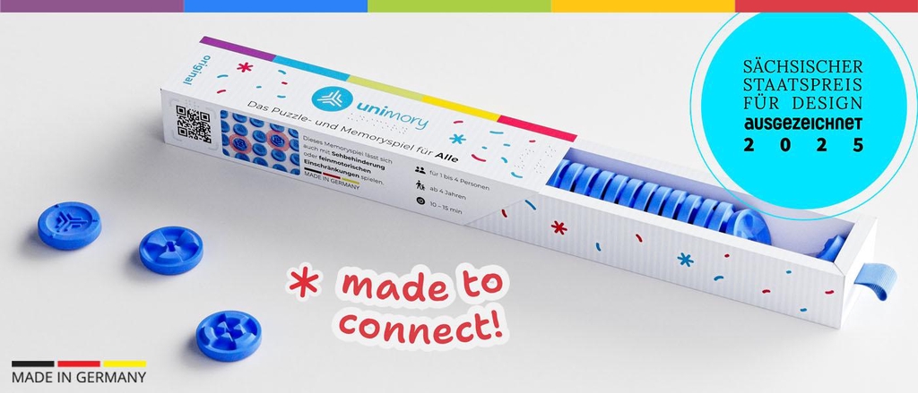 eine geöffnete Spieleverpackung liegt da, daneben einige Spielsteine und das Siegel: nominiert für den sächsischen Staatspreis für Design 2025