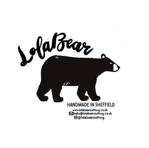 A black bear faces to the right. The text Lolabear curves around the back of the bear.