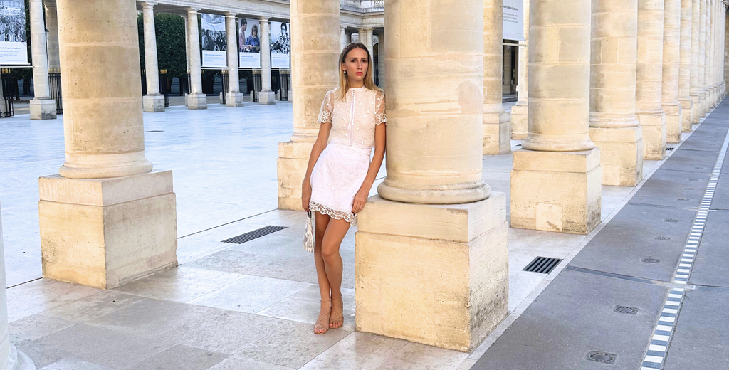 Model posing in Palais Royal, Paris in white lace bridal set for Pipa Rose Paris - perfect for a civil marriage.