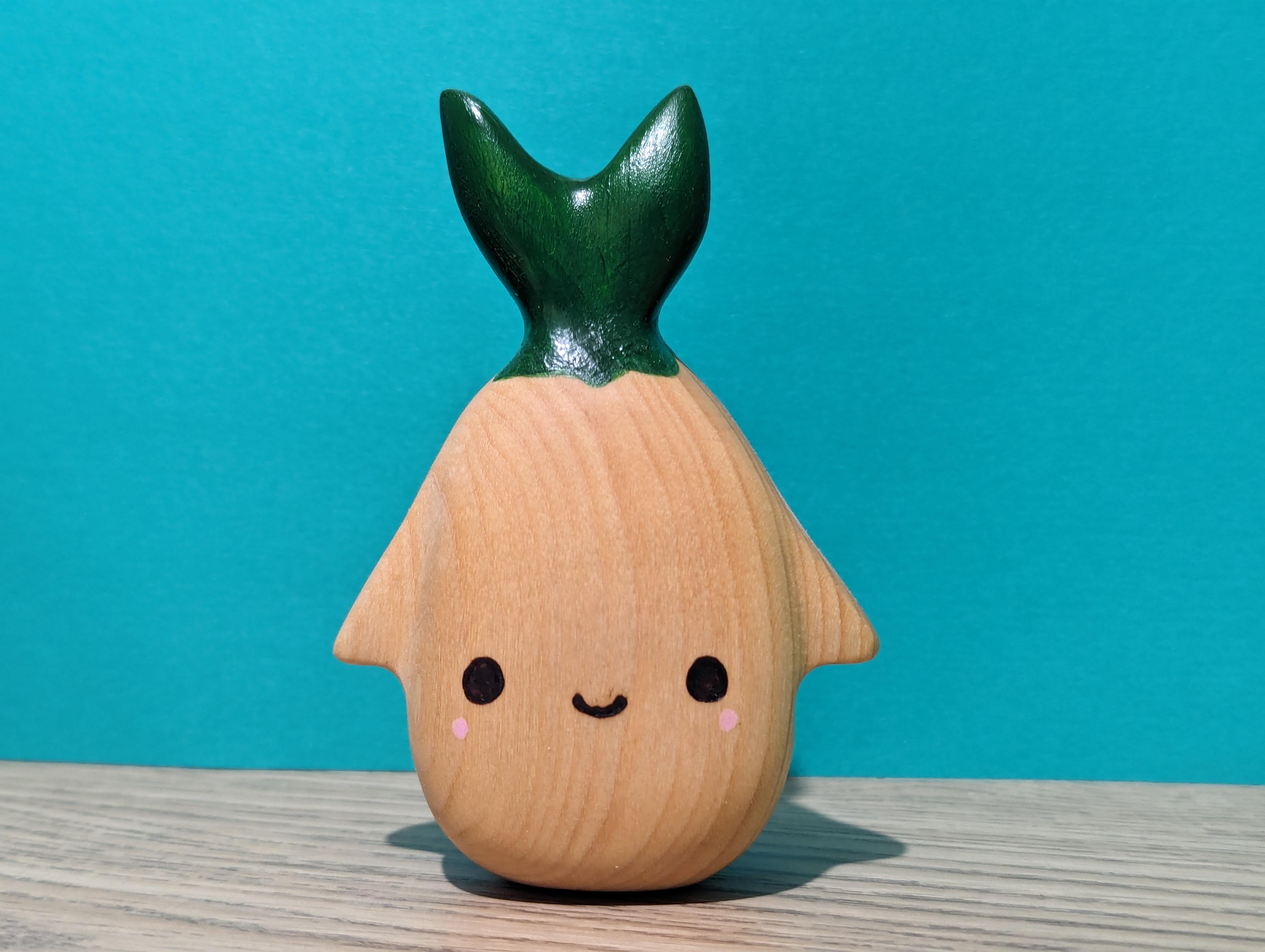 Picture of a hand carved wood sprout.