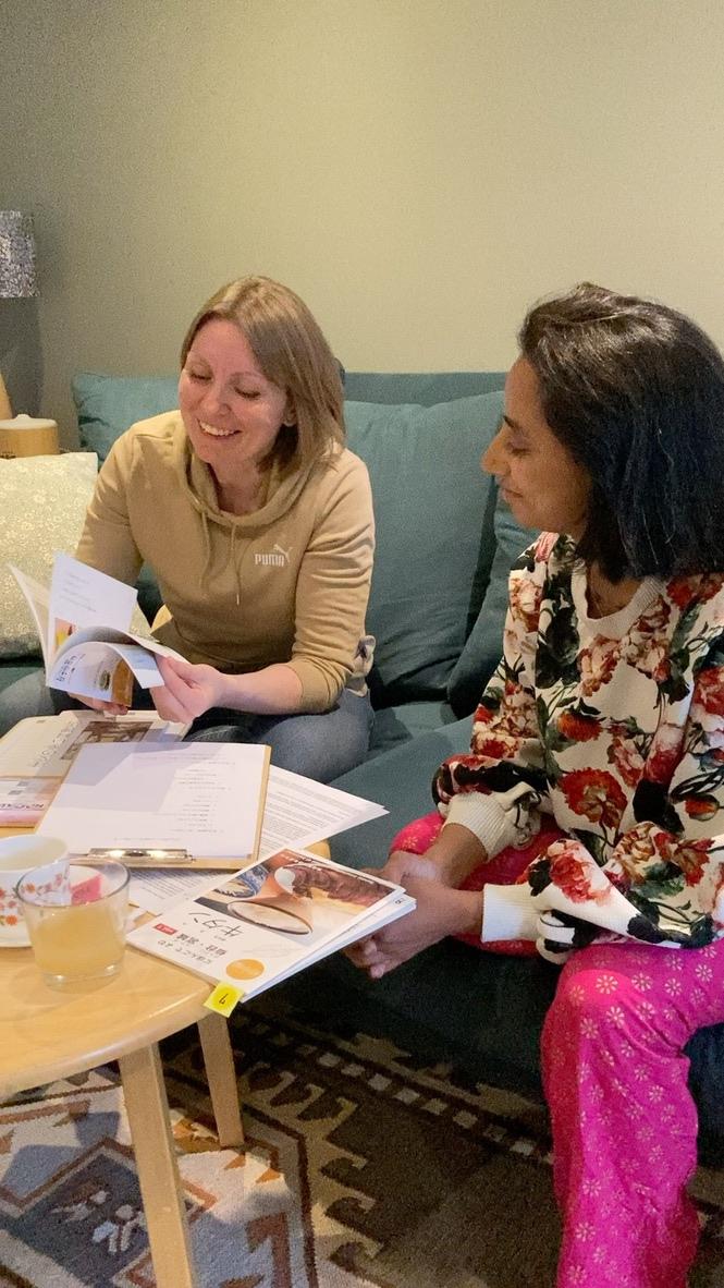 Adult learners reading graded readers together in a cosy EH10 room.