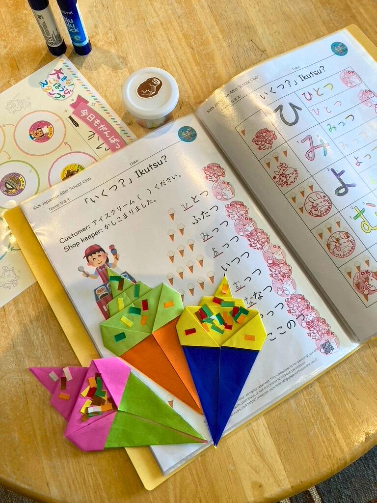 Children aged 7–12 doing Japanese crafts and reading with a PVG-checked tutor.