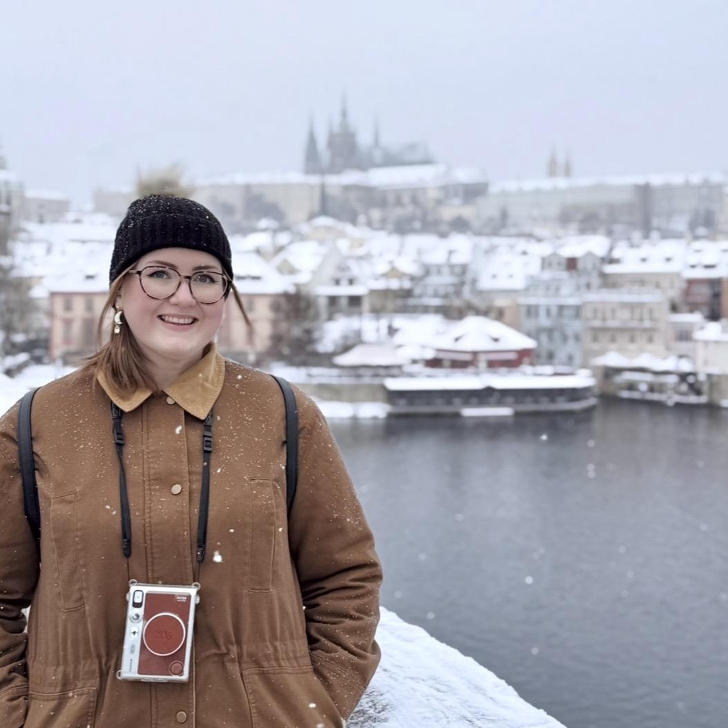 Amy, the owner of Sage and Soul, standing for a photograph, wearing a black beanie and a smile.