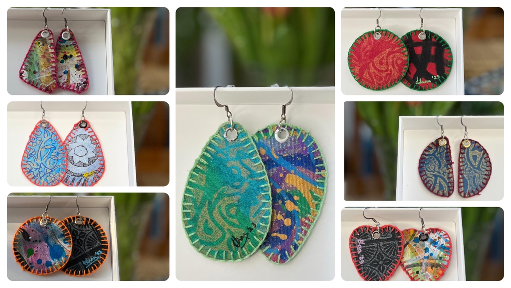 Flow art earrings , created from large pieces of art then cut into different shapes & given different coloured embroidery borders.
