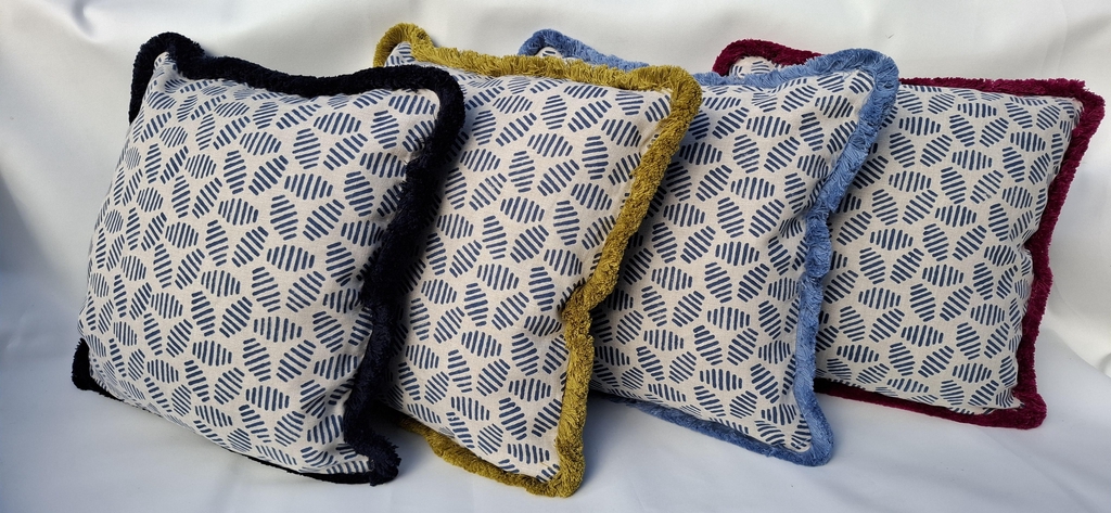 GP & J Bakers 'Bumblebee' linen fabric cushions, with a blue wool back and thick cotton fringe in different colours.