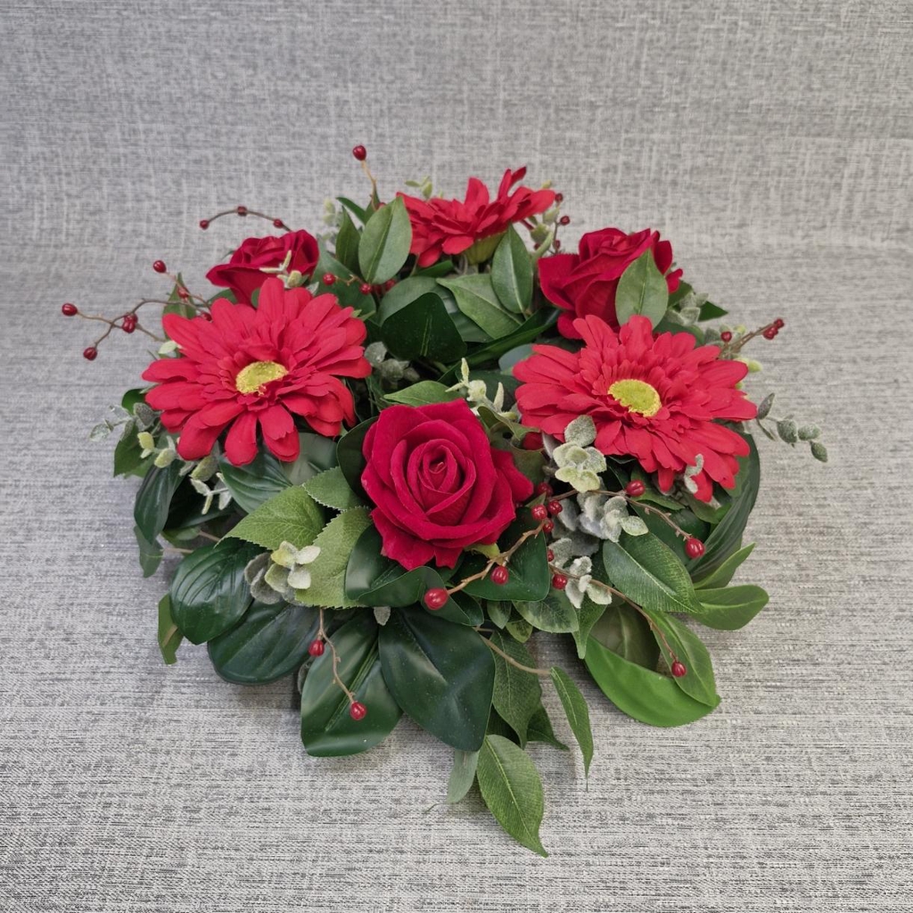 Artificial Christmas flower table centre with red roses and red gerberas