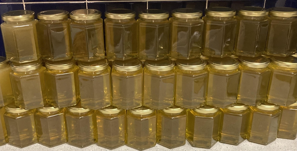 Hertfordshire Honey - honey and beeswax products for sale - rows of jars of honey stacked up