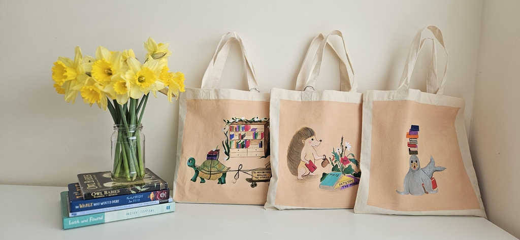 The Keepers of Stories: On Books, Folklore, and the Healing That Happens Between the Pages
A hand-painted children's book bag collection rooted in three great storytelling traditions.