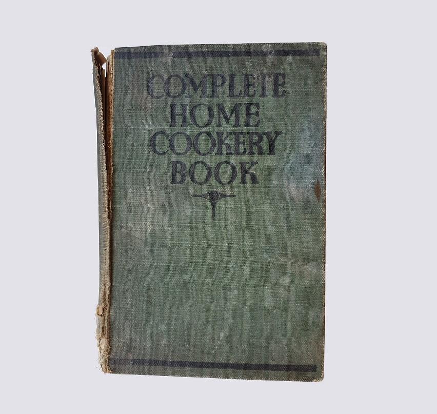 The book in its original condition before the repair. The spine is clearly loose and very damaged; the cover stained.