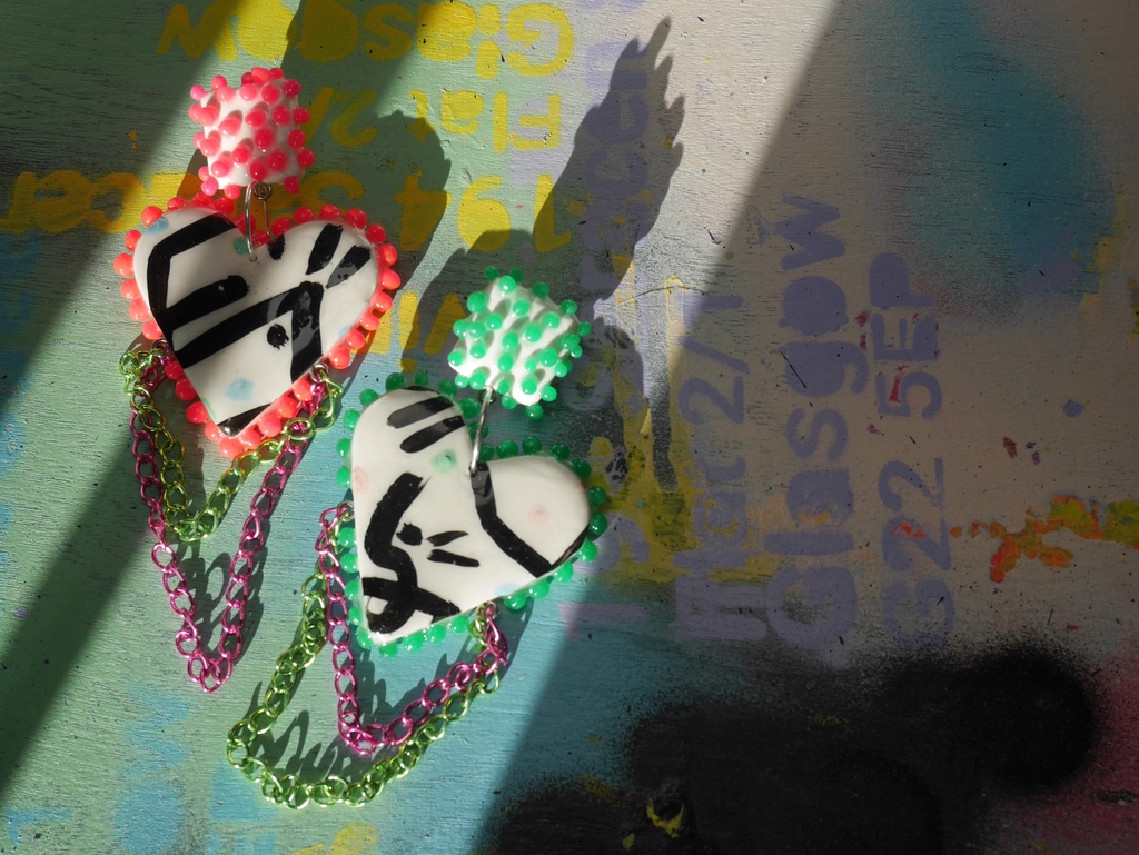 Picture of heart shape earrings with neon colours. 