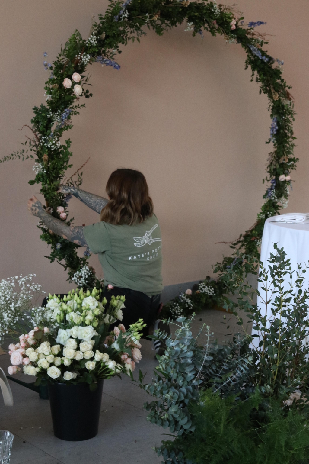 large floor standing flower hoop for a wedding to sit behind sweetheart table using a colour palette of green, white, blue and pink