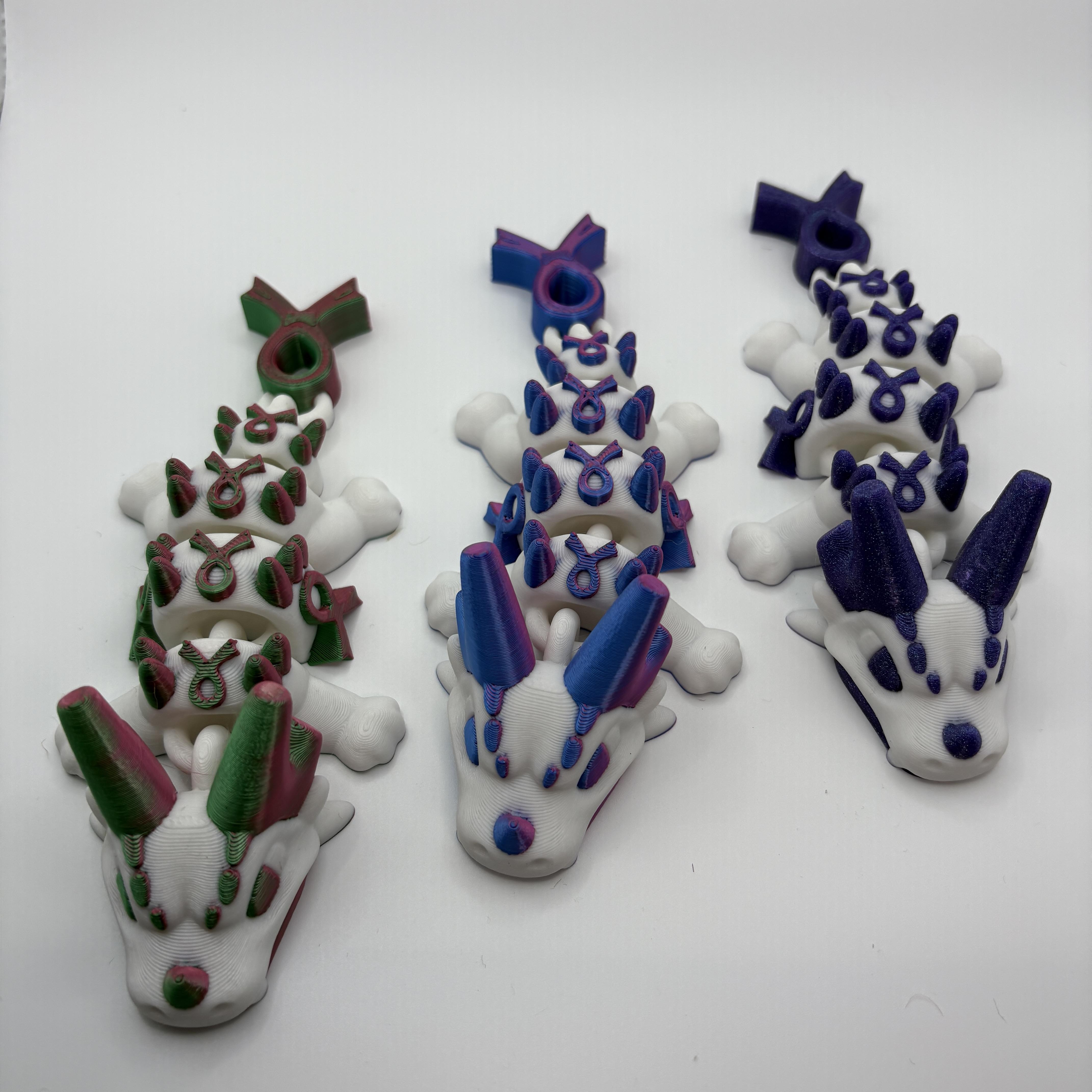 3D-printed Awareness Dragon in green, pink and white supporting S.U.R.E.