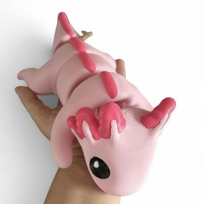 Axolotl 3D-printed toy shown on a hand.