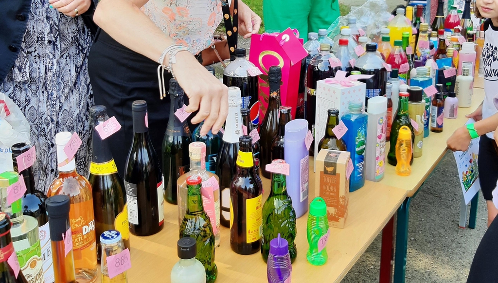 Lots of bottles laid out on a table.