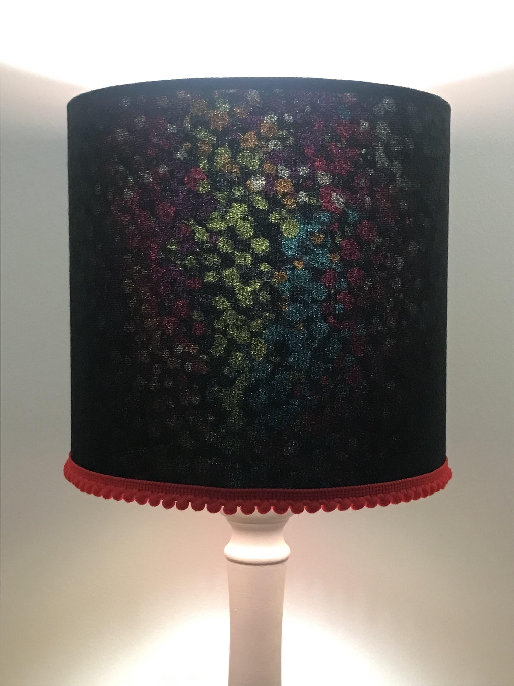 Black mock velvet lined with colour and a red pom-pom trim