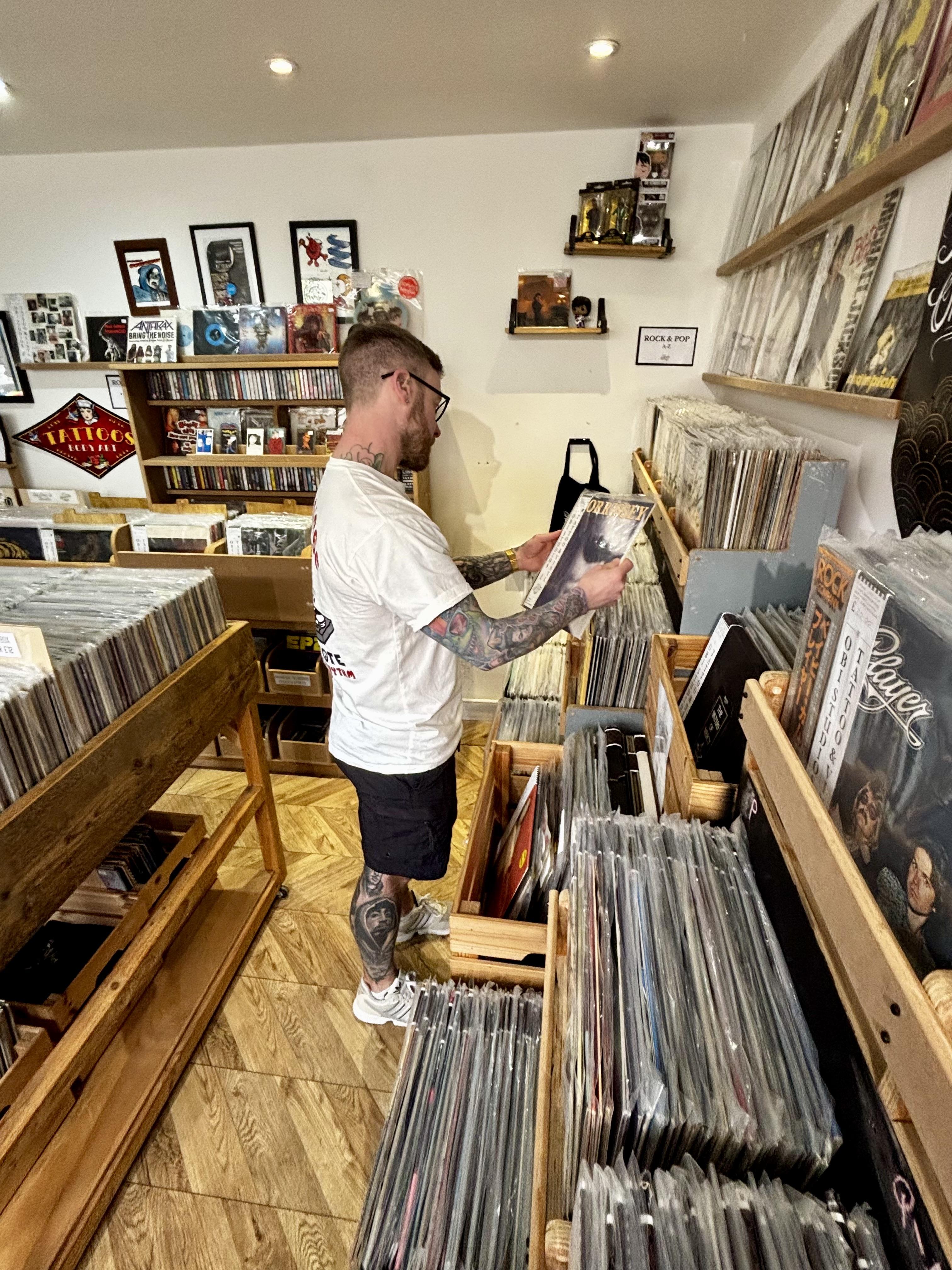 Mark browsing records inside Obi Studios independent record shop in Sedgefield, County Durham.