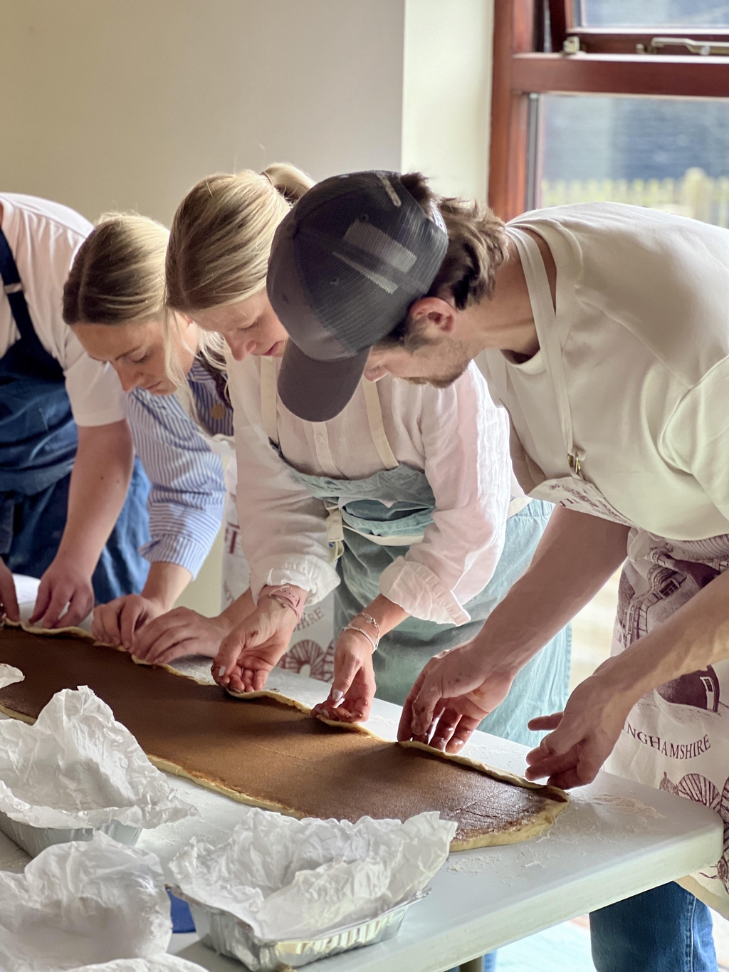 team building picture of people making cinnamon buns