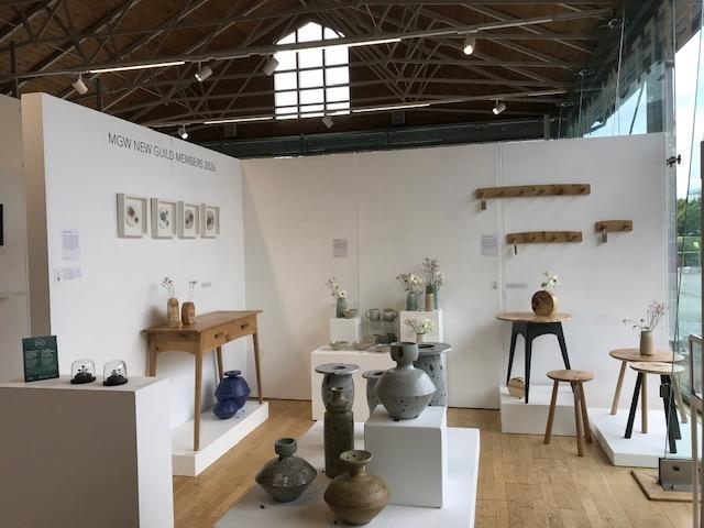 Photo of the new members exhibition showing the work of Teifi Woodworker and other new members.
