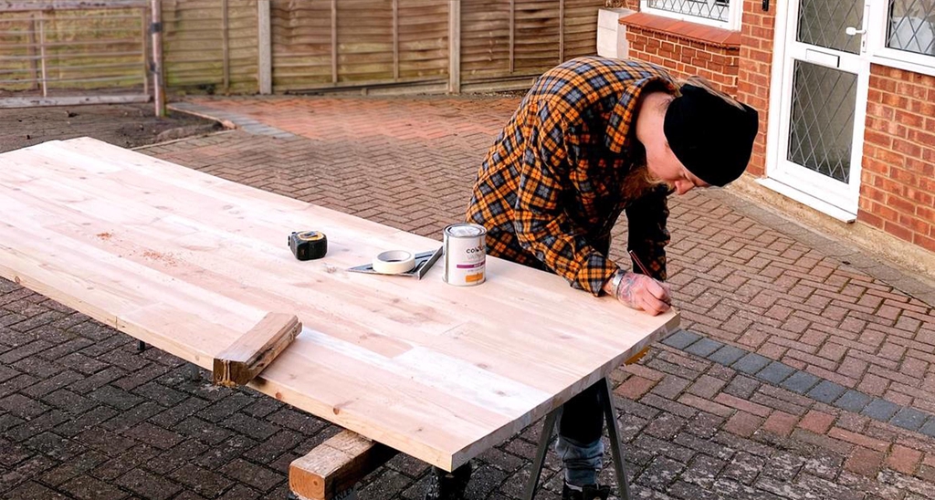 Jack performing carpentry services outside of a house