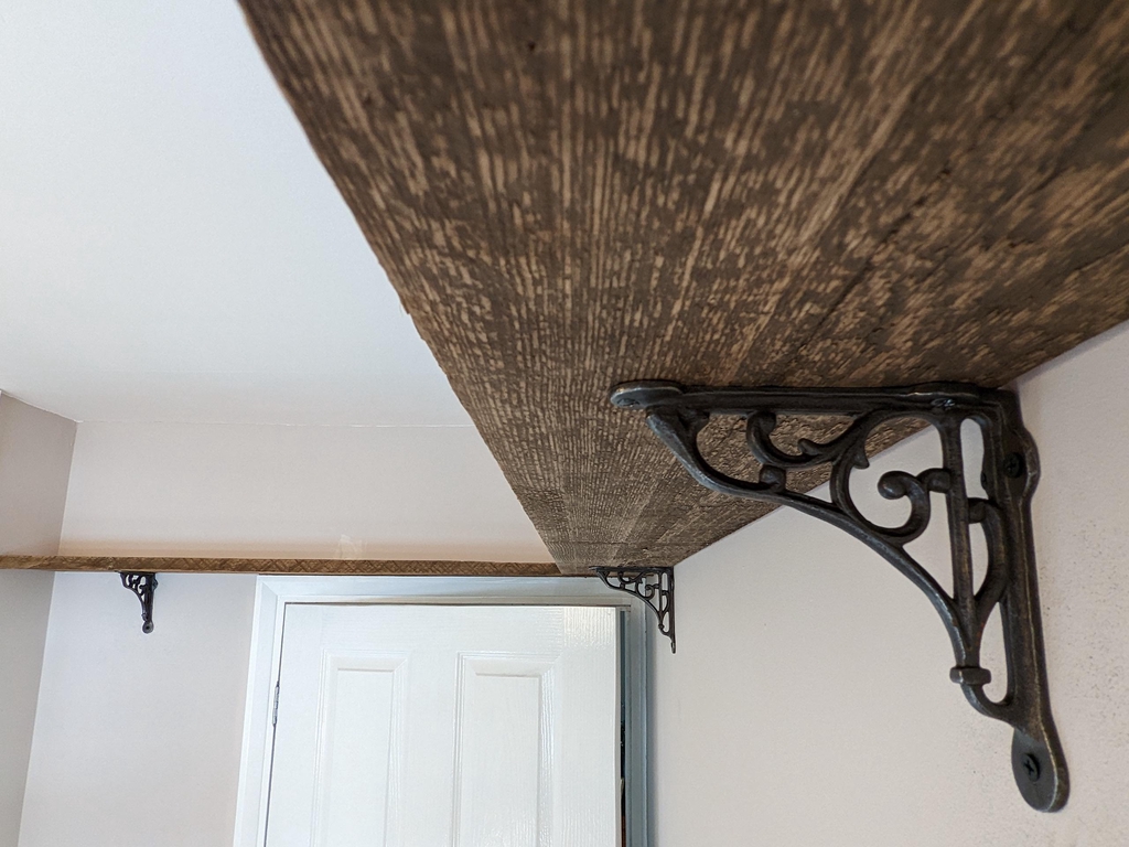 reclaimed loft beam shelves with iron brackets