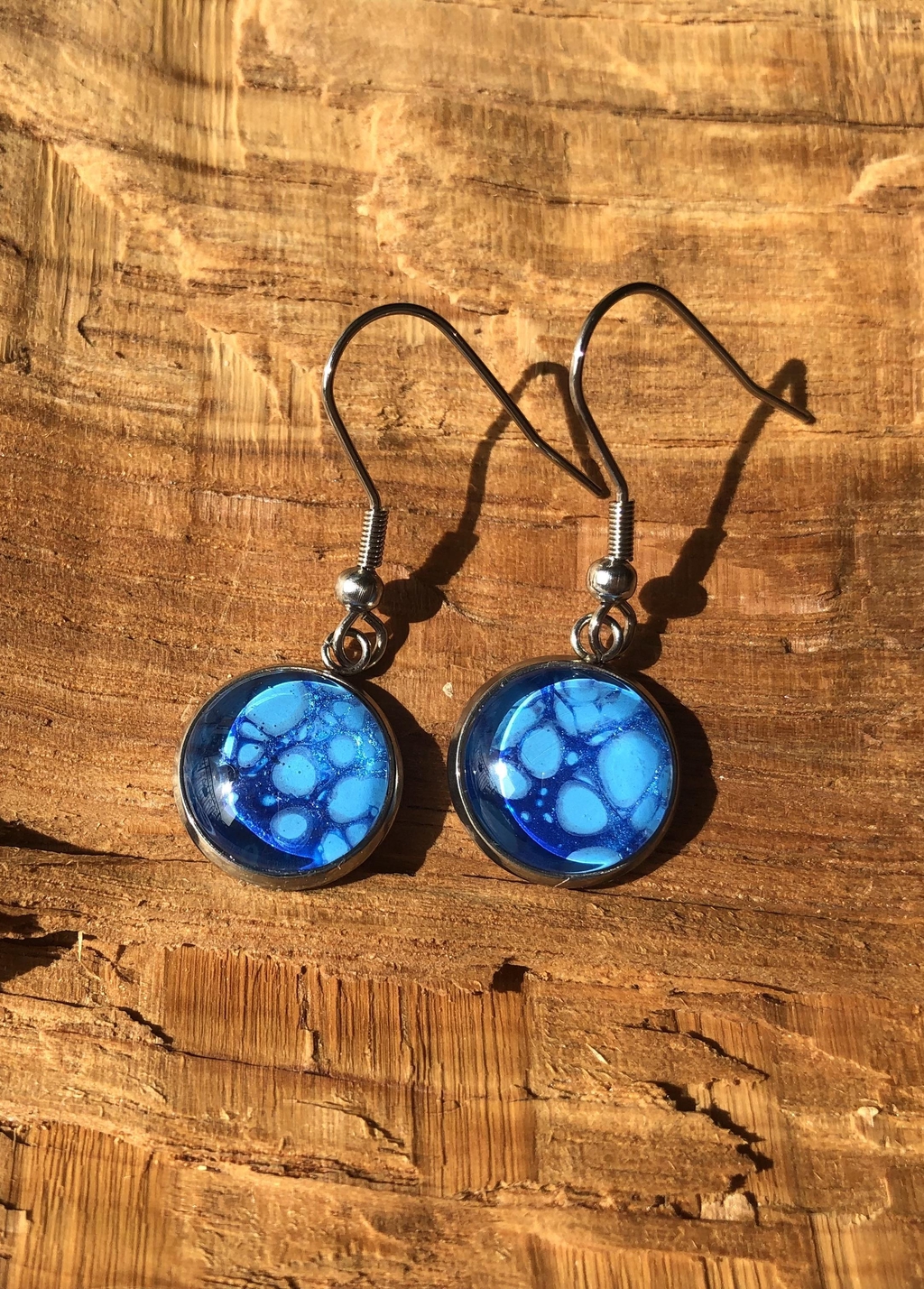Earrings with unique fluid art patterns. Hooks are hypoallergenic.