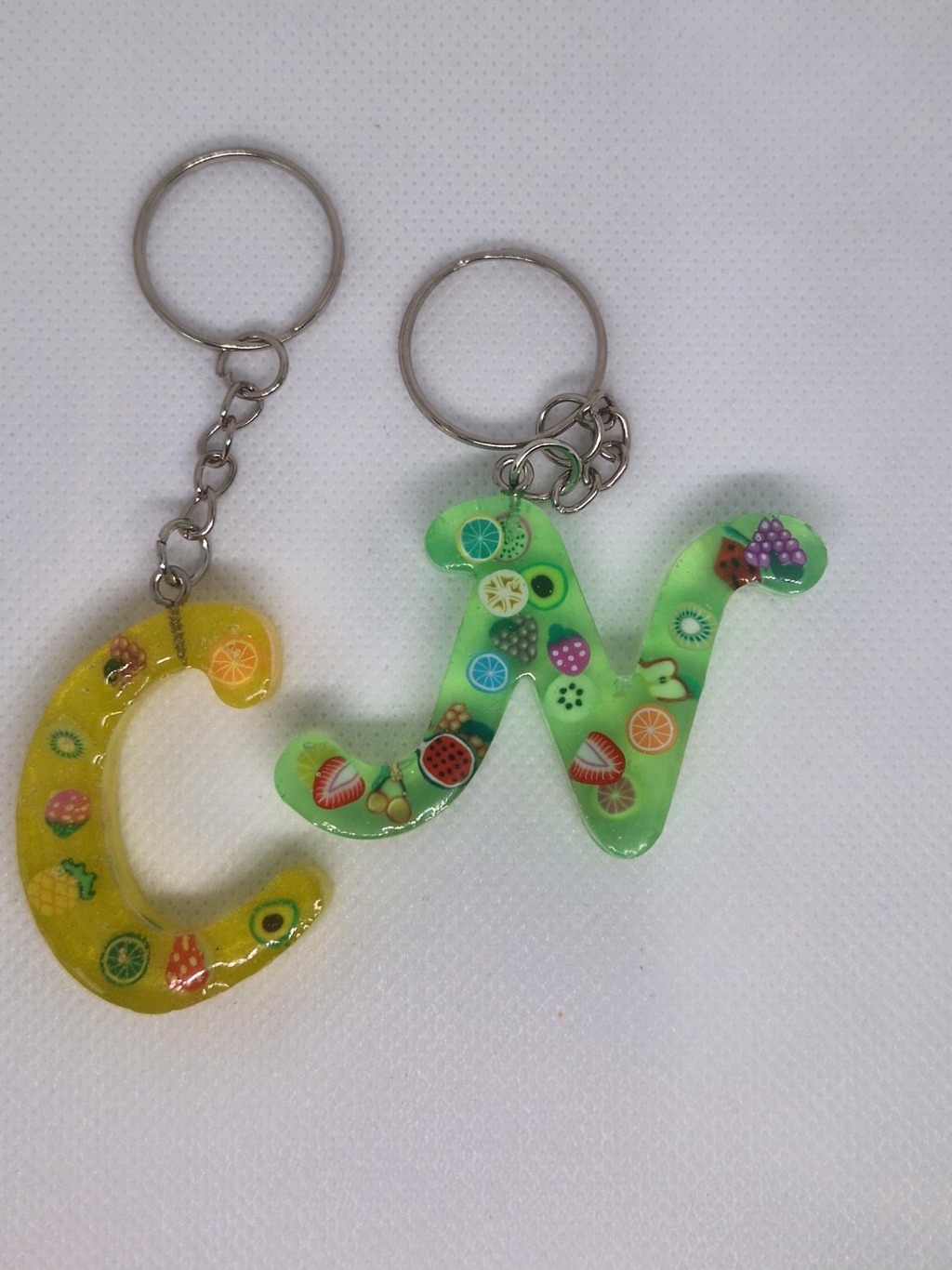 Two alphabet keyrings with fruit shaped inserts
