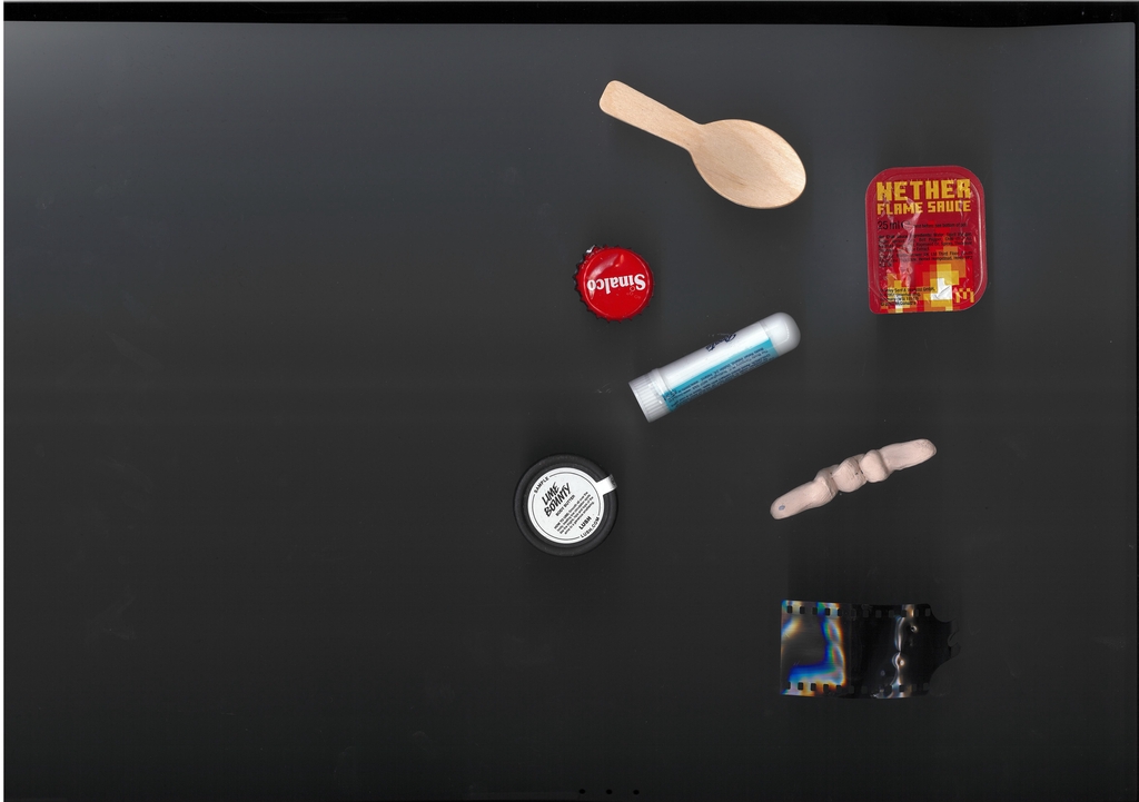 A random selection of pocket items on a black background.