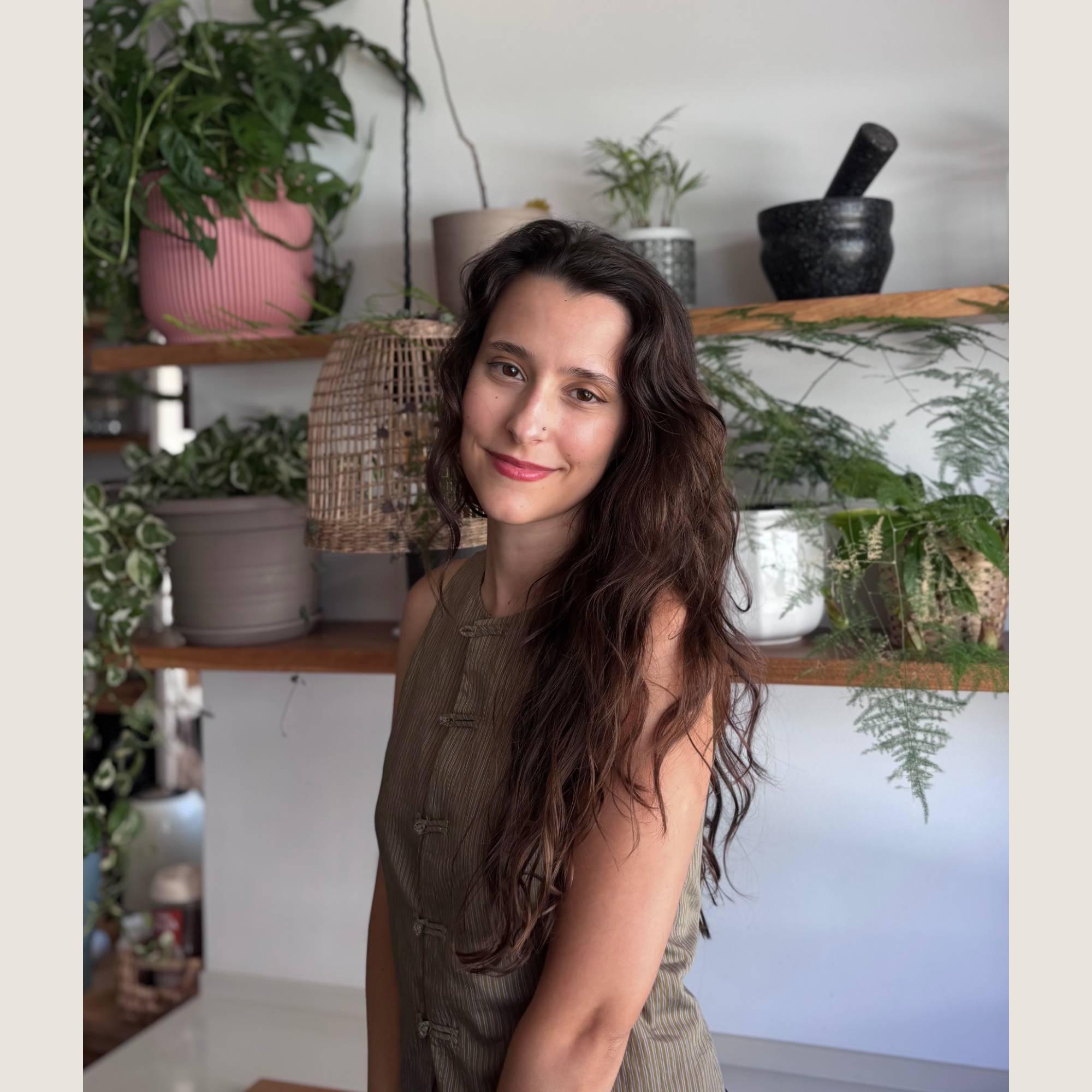 Portrait of Rita Esteves, a Portuguese ceramic artist and designer specializing in nature-inspired handmade stoneware and organic pottery.