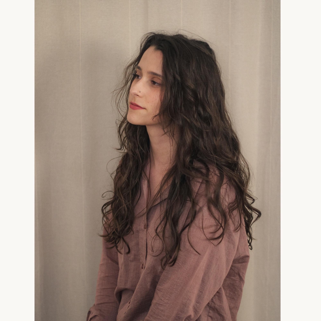 Portrait of Rita Esteves, a Portuguese ceramic artist and designer specializing in nature-inspired handmade stoneware and organic pottery.
