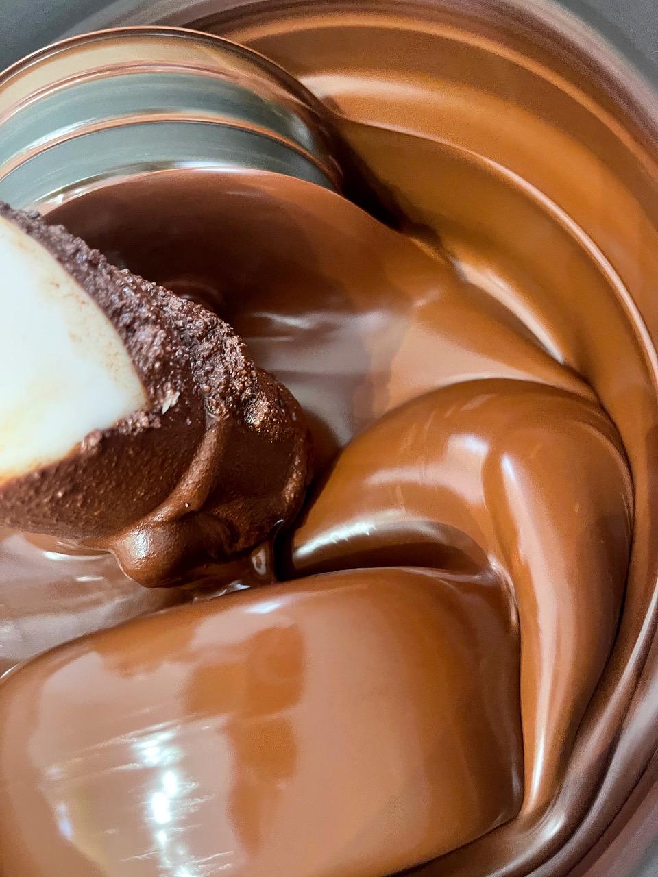 cacao and other ingredients are being grind with a stone grinder