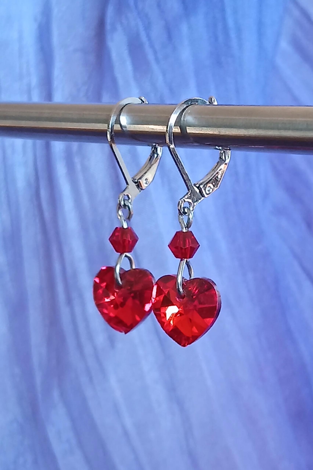 Petites boucles d'oreilles cœur rouge vif en verre.