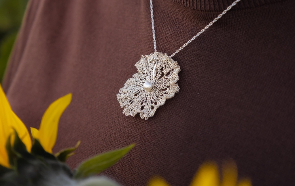 Model wearing twisted fern silver lace crocheted earrings.