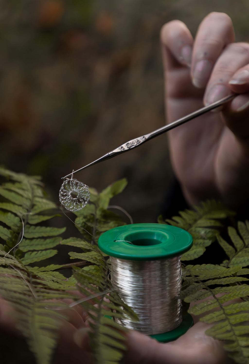 An antique crochet hook and a reel of recycled fine silver. Demonstrating the creative process.