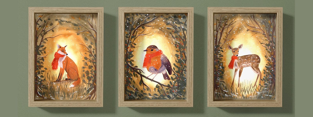 Hand-painted watercolour cards featuring a fox, a robin and a fawn in a woodland setting, framed as small art prints.